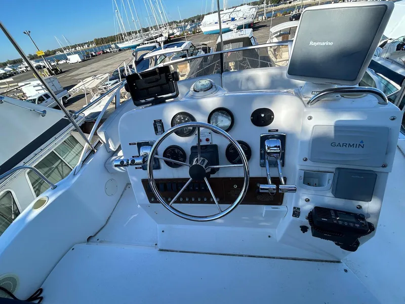 Slide: The Image of 1999 Silverton 351 Sedan Cruiser helm with Garmin navigation system and controls. - 6
