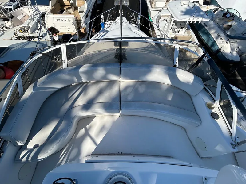 Slide: The Image of 1999 Silverton 351 Sedan Cruiser boat deck with seating area, docked at marina. - 8