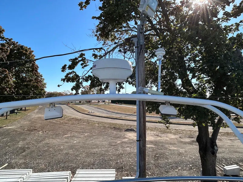 Slide: The Image of Radar equipment on 1999 Silverton 351 Sedan Cruiser, surrounded by trees and clear sky. - 9