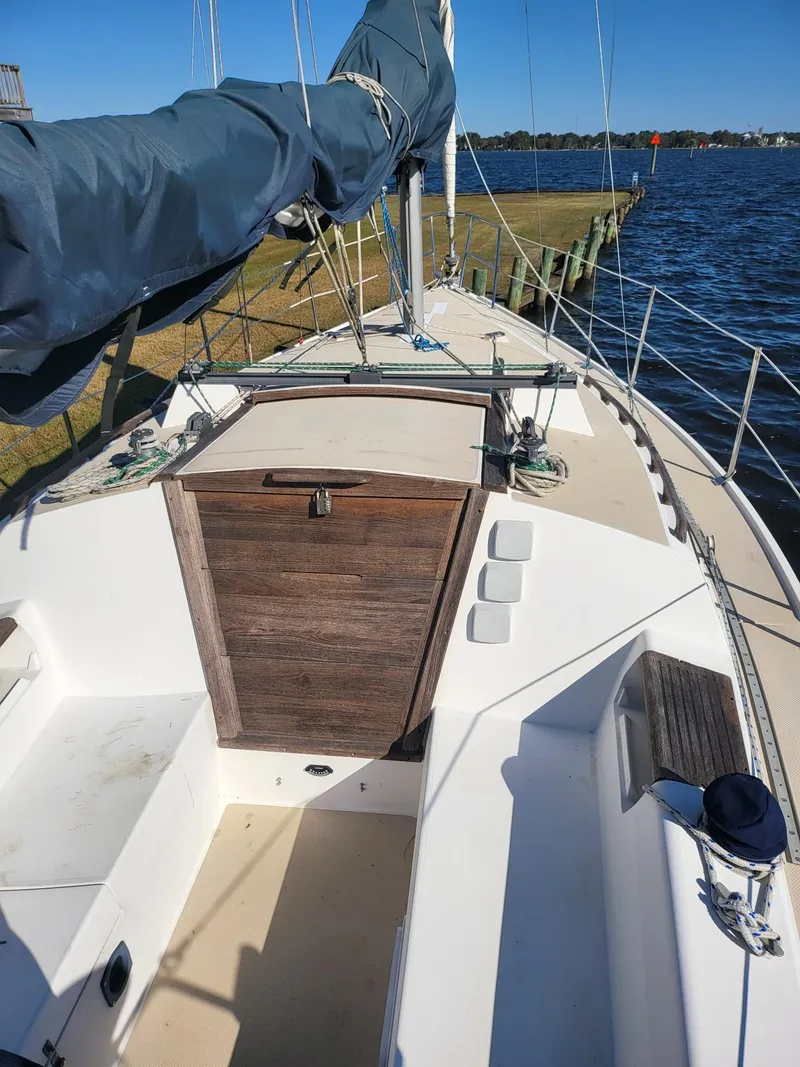 Slide: The Image of 1988 Catalina 30 sailboat on water with blue cover. - 23