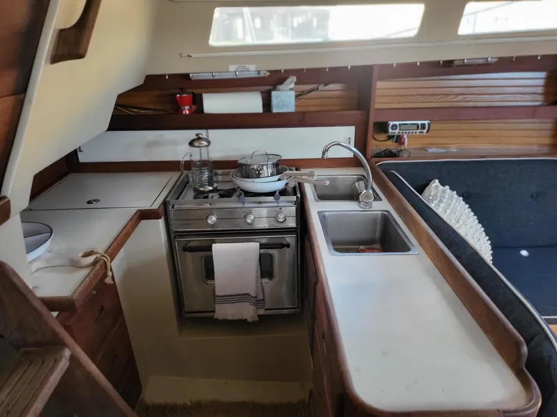 Slide: The Image of Interior of a 1988 Catalina 30 yacht with kitchen and seating area. - 24