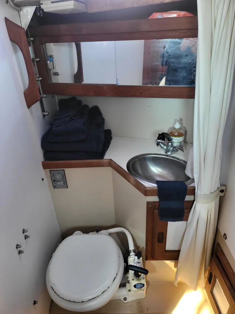 Slide: The Image of 1988 Catalina 30 yacht bathroom with toilet and sink. - 25
