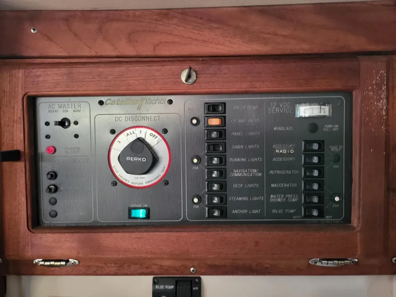 Slide: The Image of 1988 Catalina 30 yacht control panel with wood trim. - 26