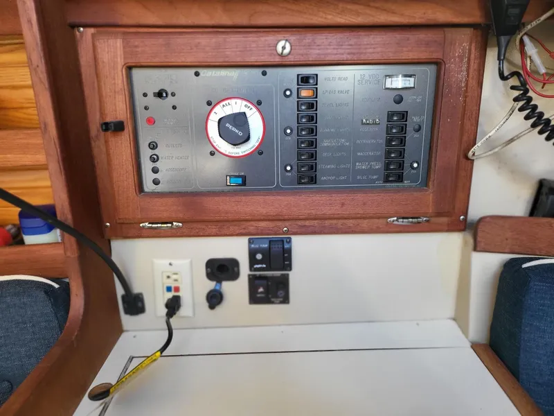 Slide: The Image of Control panel of a 1988 Catalina 30 yacht with wooden frame. - 27
