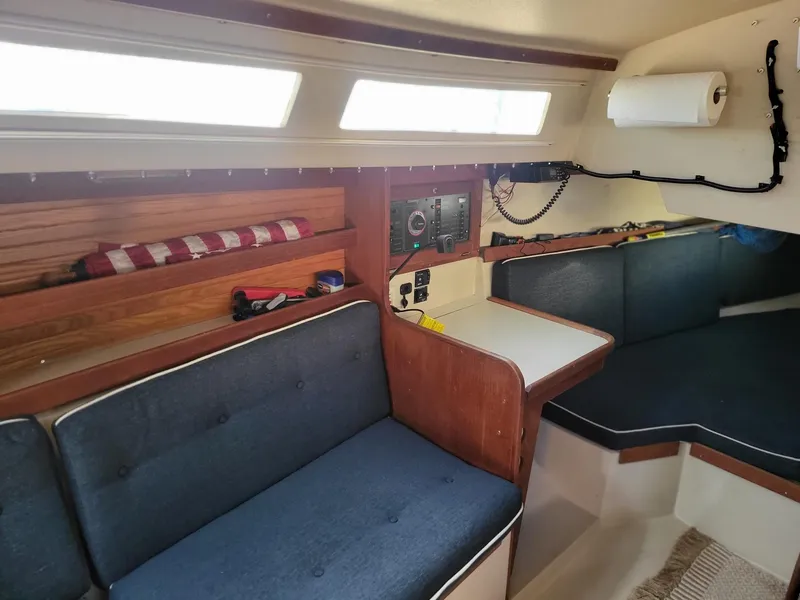 Slide: The Image of Interior of a 1988 Catalina 30 sailboat with blue cushions. - 29
