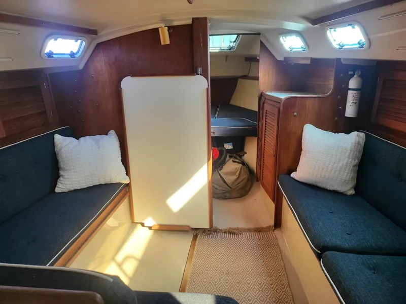 Slide: The Image of Interior of a 1988 Catalina 30 yacht with cozy seating areas. - 3