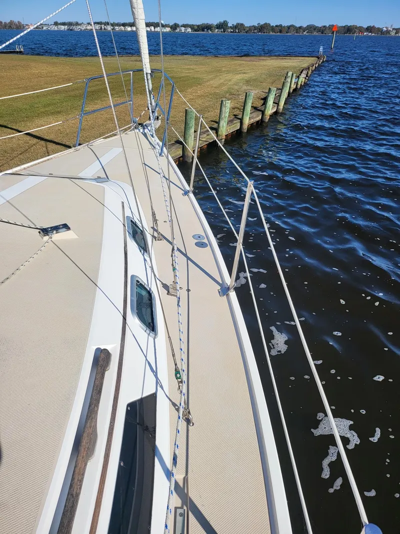 Slide: The Image of 1988 Catalina 30 sailboat docked, calm waters. - 30