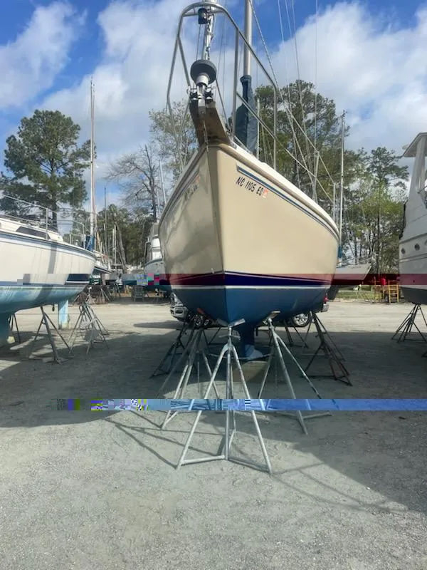 Slide: The Image of 1988 Catalina 30 sailboat on stands outdoors. - 34