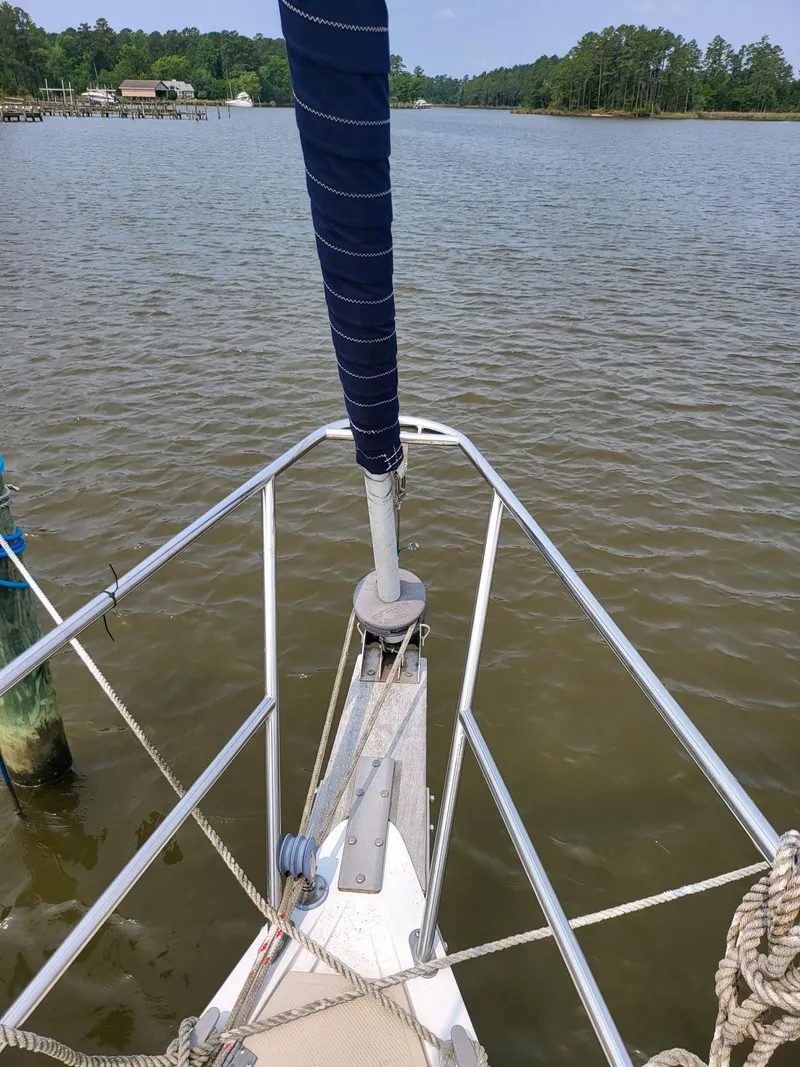 Slide: The Image of Bow of a 1988 Catalina 30 sailboat on calm water. - 6