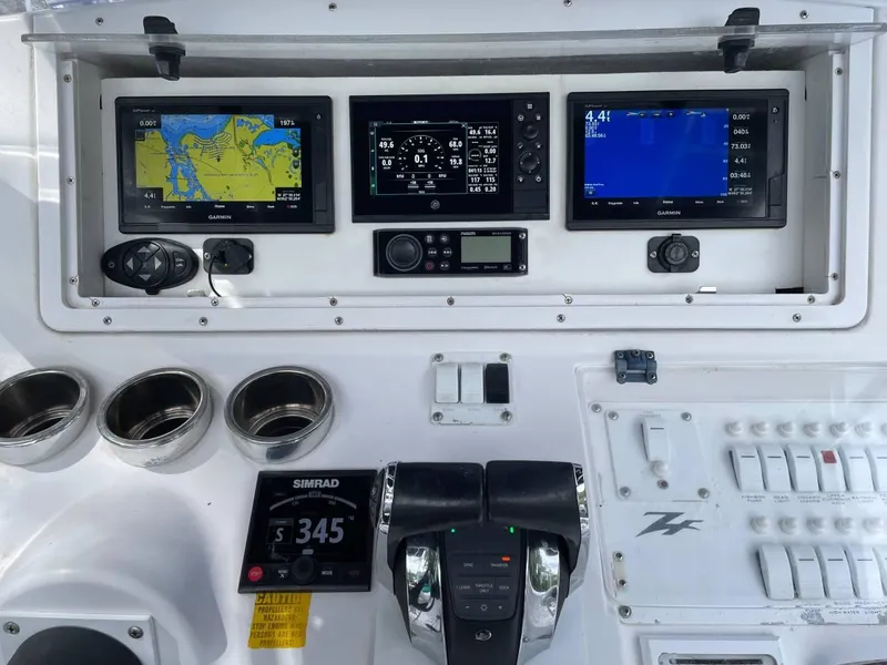Slide: The Image of Dashboard of a 2004 Donzi 35 ZF Open boat with navigation screens and controls. - 10