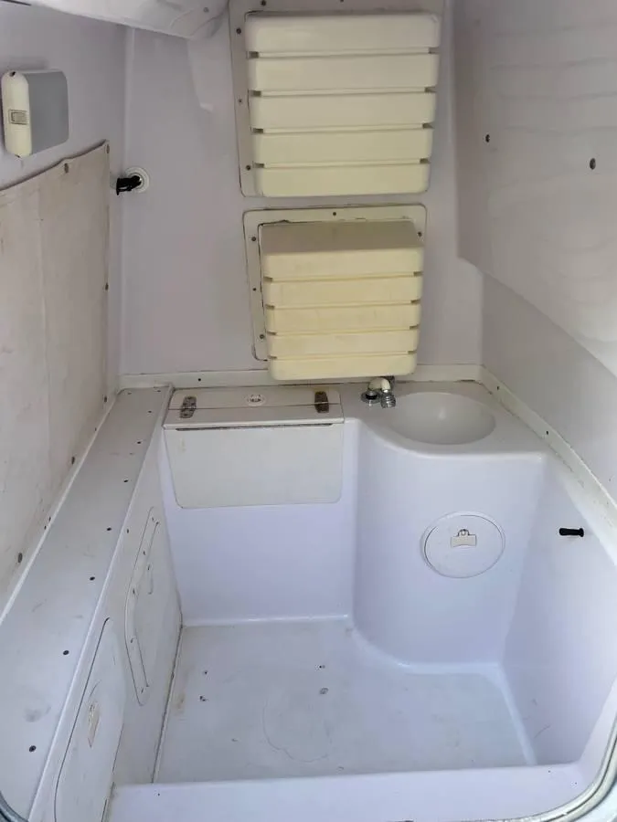 Slide: The Image of 2004 Donzi 35 ZF Open boat interior with sink and storage compartments. - 13