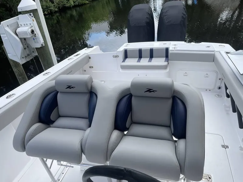 Slide: The Image of 2004 Donzi 35 ZF Open boat interior with dual seats and twin engines. - 15