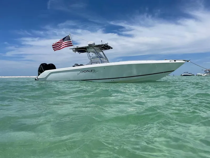 Slide: The Image of 2004 Donzi 35 ZF Open boat with American flag on clear water. - 5