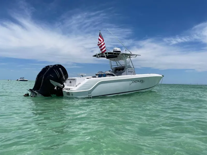 Slide: The Image of 2004 Donzi 35 ZF Open boat on clear water with American flag. - 6