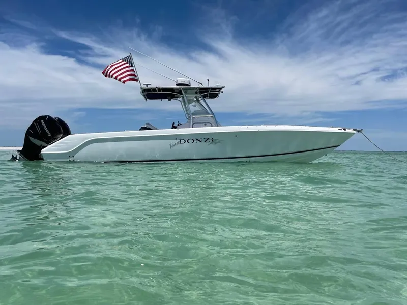 Slide: The Image of 2004 Donzi 35 ZF Open boat with American flag on calm water. - 7