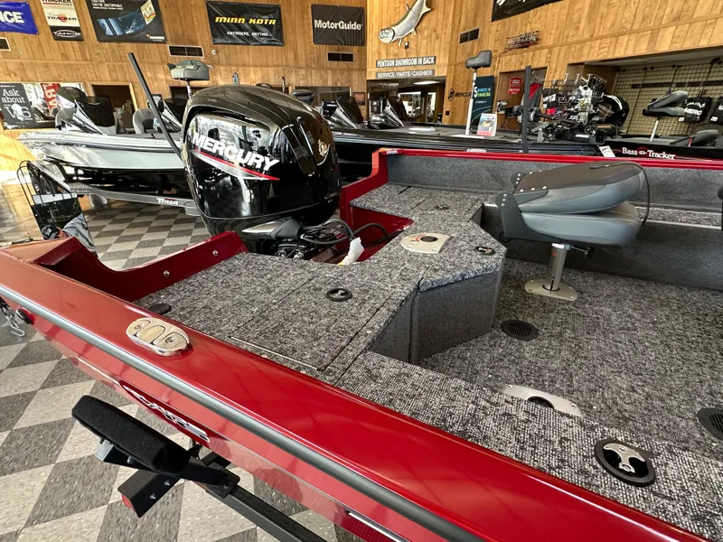 Slide: The Image of 2025 Tracker Pro Guide V-16 SC boat with Mercury engine in showroom. - 4