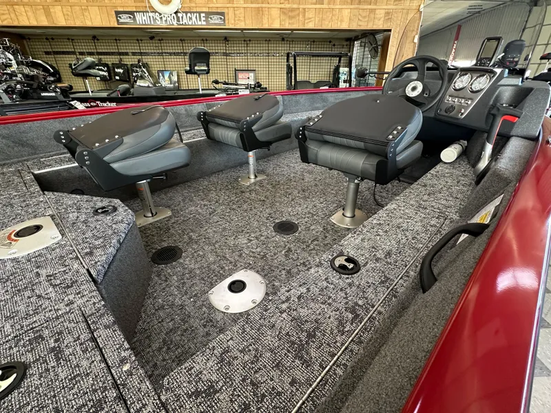 Slide: The Image of 2025 Tracker Pro Guide V-16 SC boat interior with gray seating and modern dashboard. - 5