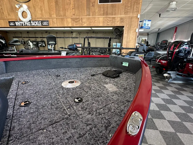 Slide: The Image of 2025 Tracker Pro Guide V-16 SC boat interior in showroom, featuring spacious deck and modern design. - 6