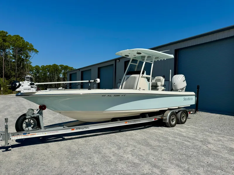 Slide: The Image of 2022 ShearWater 260 Carolina Flair boat on trailer, parked outdoors. - 1
