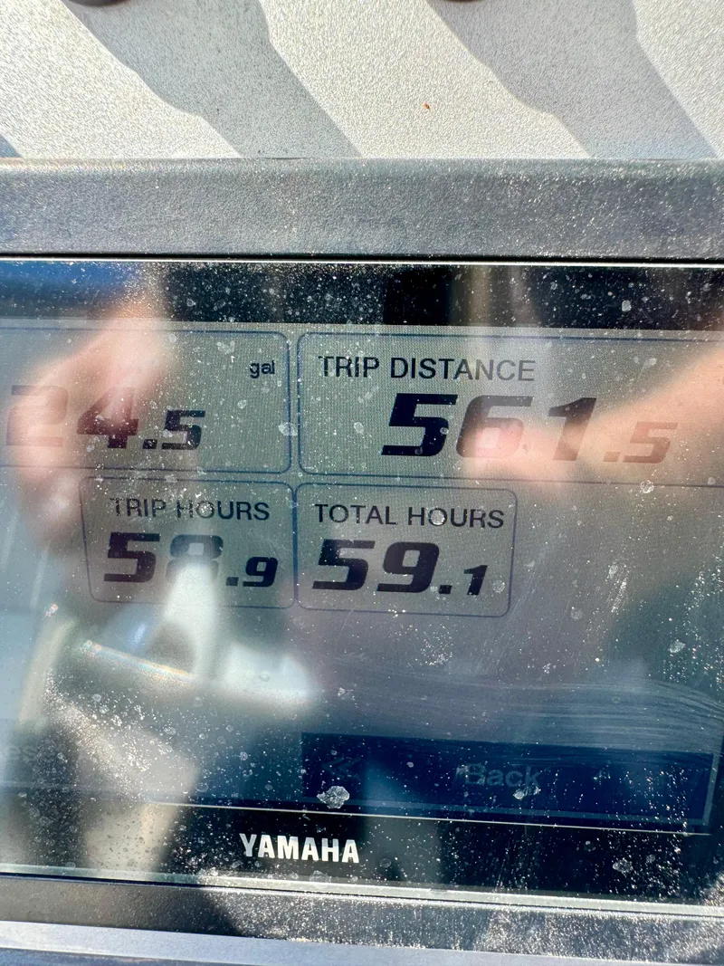 Slide: The Image of Close-up of Yamaha boat display showing trip distance and hours on ShearWater 260 Carolina Flair. - 12