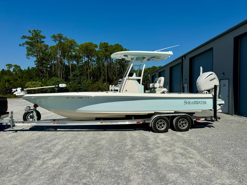 Slide: The Image of 2022 ShearWater 260 Carolina Flair boat on trailer, parked outdoors. - 2