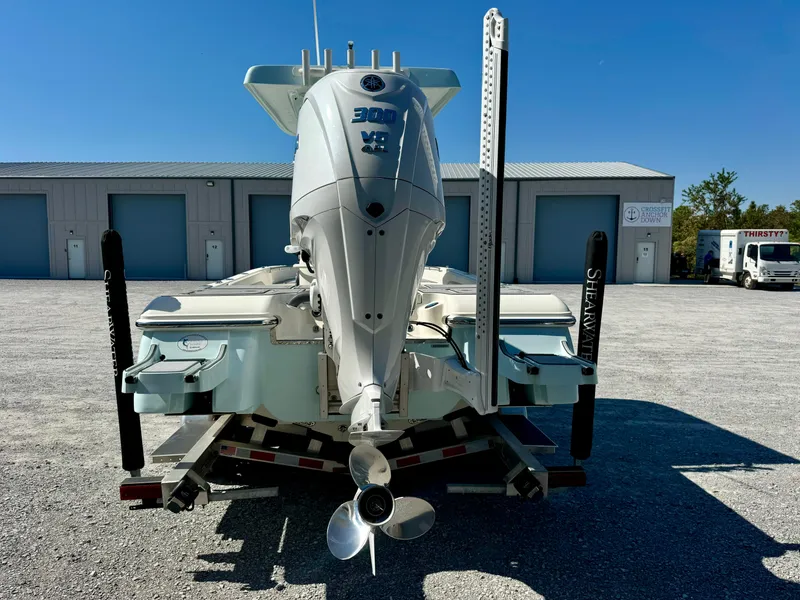 Slide: The Image of 2022 ShearWater 260 Carolina Flair boat with powerful engine, parked in storage facility. - 5
