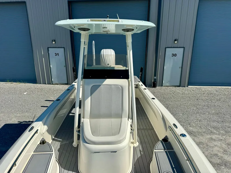 Slide: The Image of 2022 ShearWater 260 Carolina Flair boat, docked near storage units. - 7