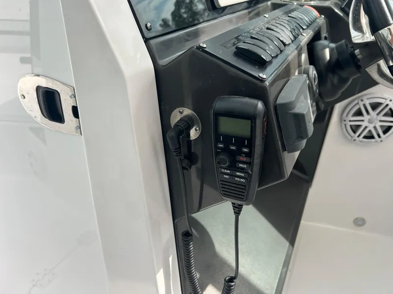 Slide: The Image of 2024 Blackfin 272 DC boat dashboard with radio and control panel. - 11