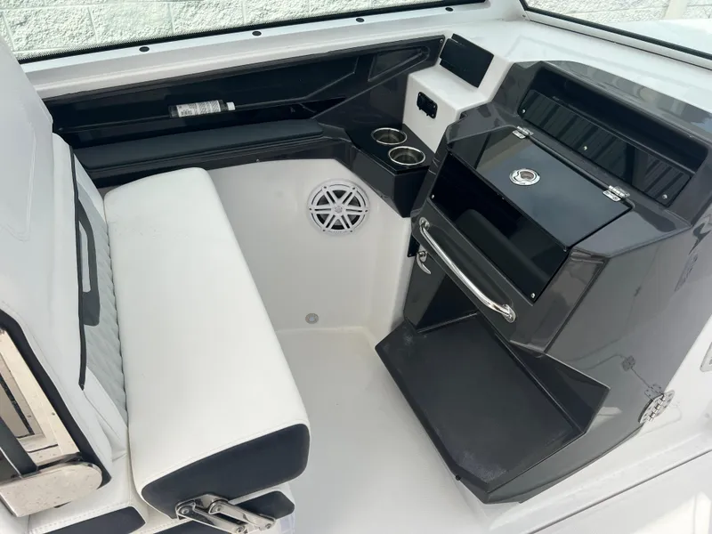 Slide: The Image of 2024 Blackfin 272 DC boat interior with seating, storage, and cup holders. - 12