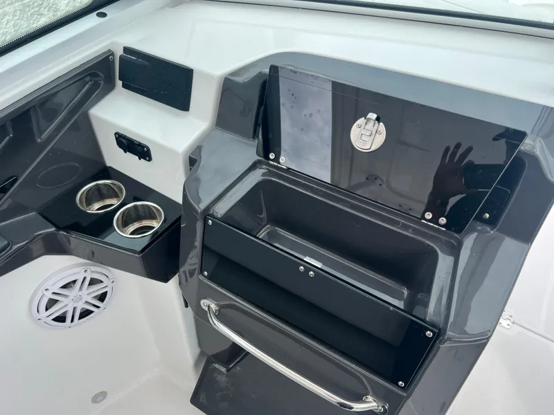 Slide: The Image of 2024 Blackfin 272 DC boat interior with cup holders and storage compartments. - 14