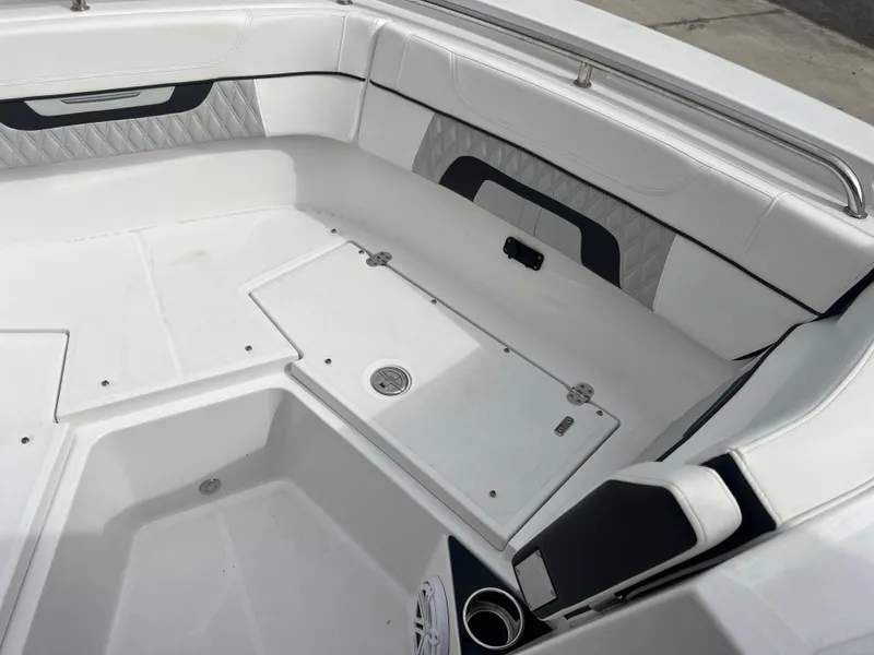 Slide: The Image of 2024 Blackfin 272 DC boat interior with white seating and storage compartments. - 20