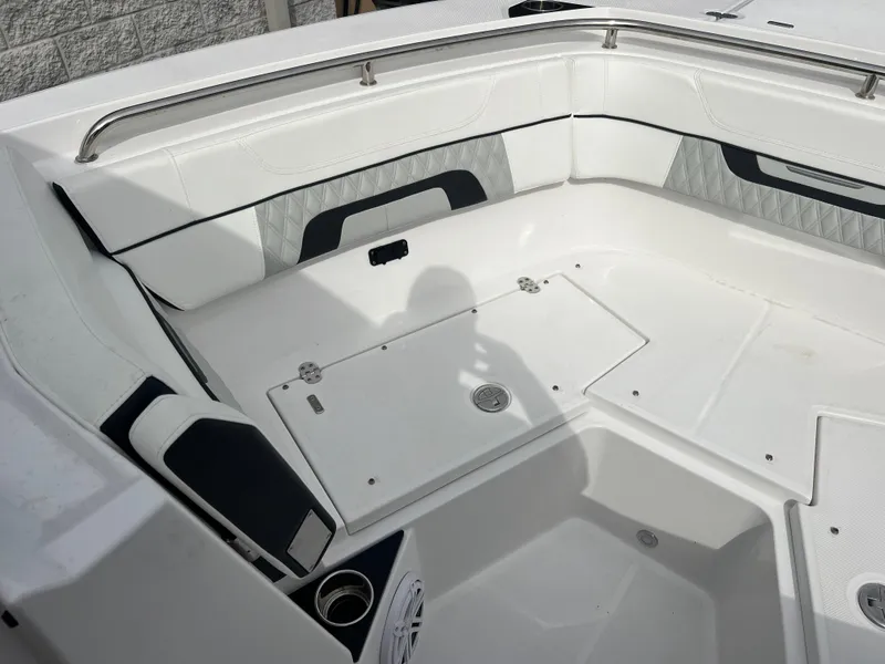 Slide: The Image of 2024 Blackfin 272 DC boat interior with white seating and storage compartments. - 21