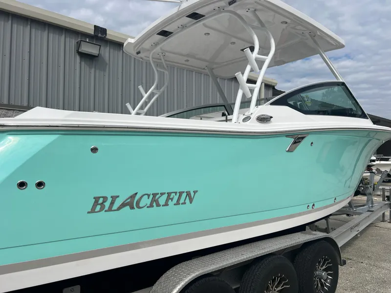 Slide: The Image of 2024 Blackfin 272 DC boat in light blue on a trailer, side view. - 36
