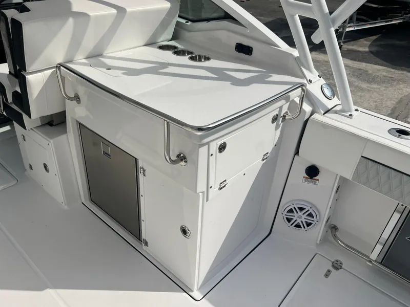 Slide: The Image of 2024 Blackfin 272 DC boat interior with storage and stainless steel fixtures. - 43