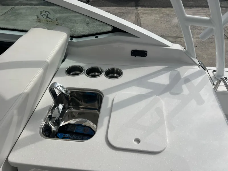 Slide: The Image of 2024 Blackfin 272 DC boat console with cup holders and control panel. - 45