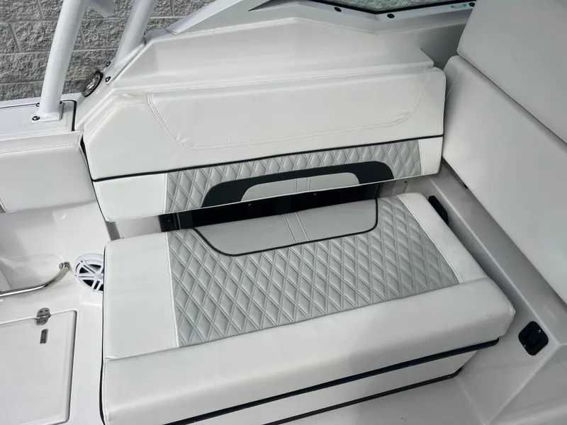 Slide: The Image of 2024 Blackfin 272 DC boat interior with white and gray diamond-stitched seating. - 48
