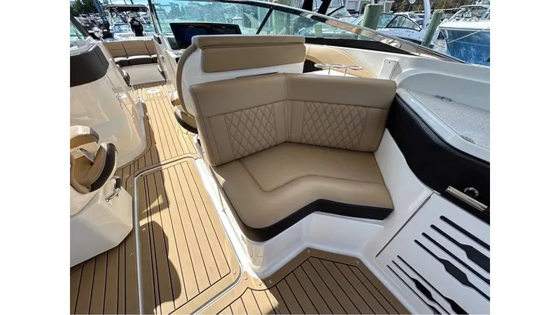 Slide: The Image of Luxurious interior of 2019 Sea Ray 310 SLX boat with tan seating and wood flooring. - 10