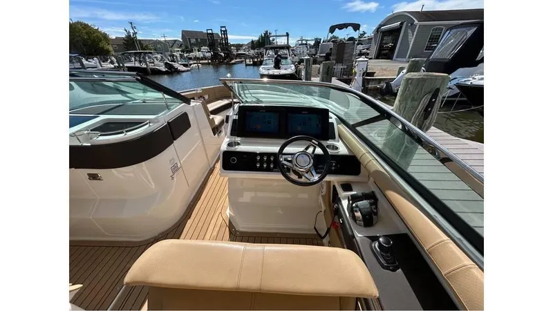 Slide: The Image of 2019 Sea Ray 310 SLX boat cockpit with modern controls and waterfront view. - 11