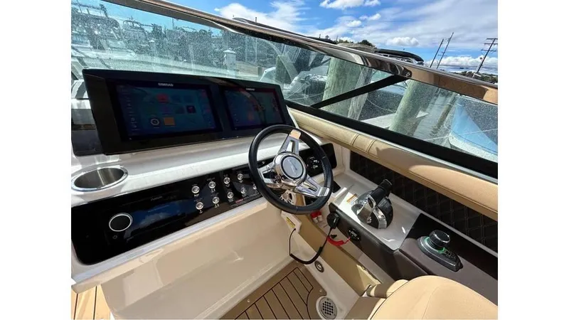 Slide: The Image of 2019 Sea Ray 310 SLX boat cockpit with modern controls and navigation screens. - 13