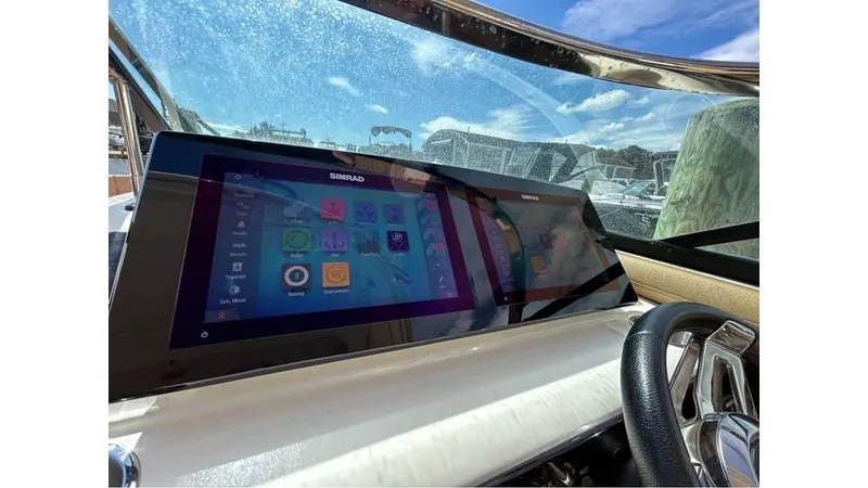 Slide: The Image of 2019 Sea Ray 310 SLX dashboard with Simrad touchscreen displays. - 14