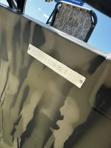 Slide: The Image of 2024 SeaArk 31652 CRAPPIE boat with identification plate, camouflage design. - 11