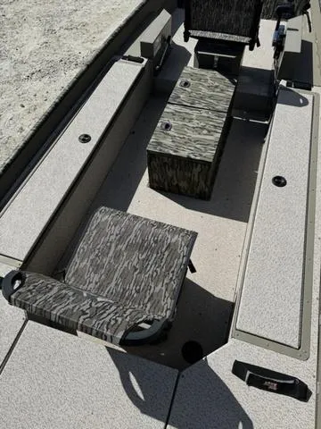 Slide: The Image of 2024 SeaArk 31652 CRAPPIE boat interior with camo seating and storage compartments. - 6
