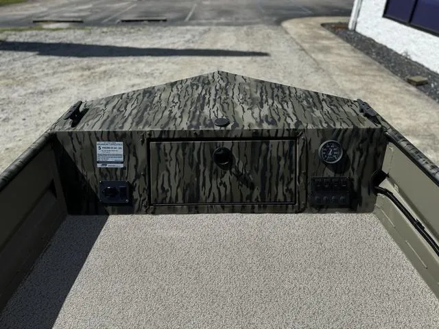 Slide: The Image of 2024 SeaArk 31652 CRAPPIE boat interior with camouflage design and control panel. - 8