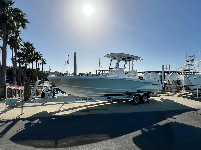 The Image of 2025 Caymas 281 HB boat on trailer, sunny marina backdrop. - 0