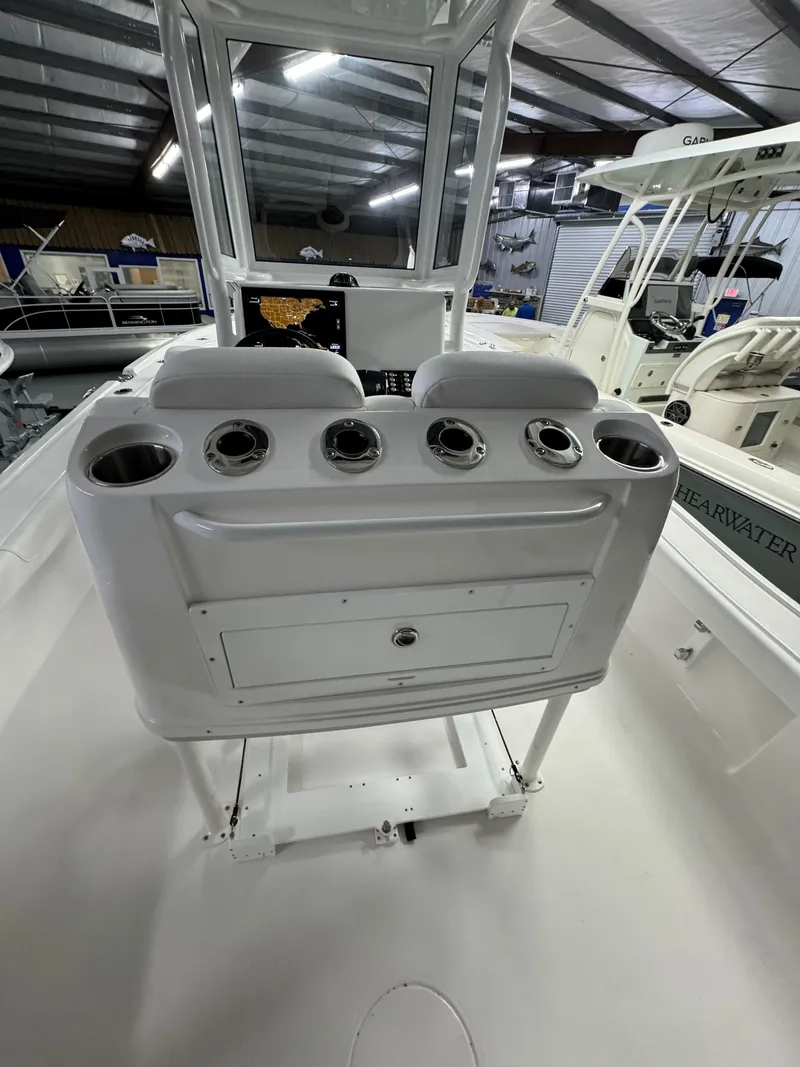 Slide: The Image of 2025 Caymas 281 HB boat interior with rod holders and storage in a showroom. - 29