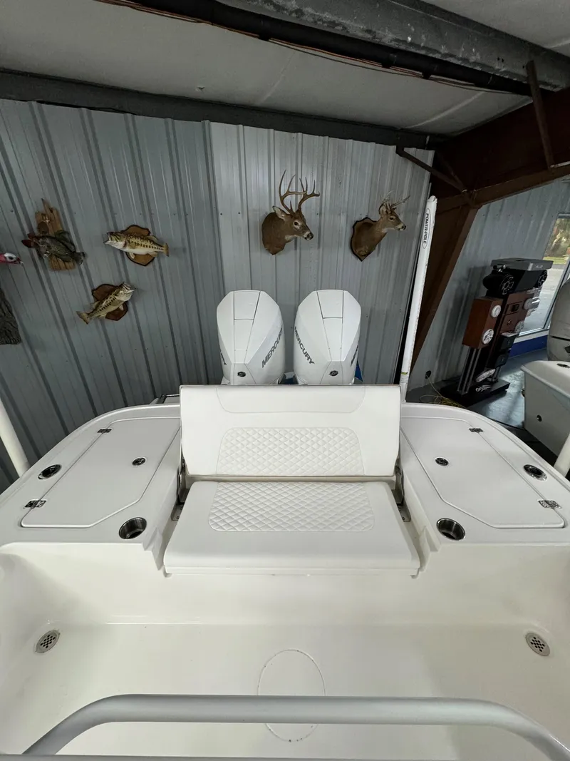 Slide: The Image of 2025 Caymas 281 HB boat interior with mounted engines and wall-mounted animal decor. - 30