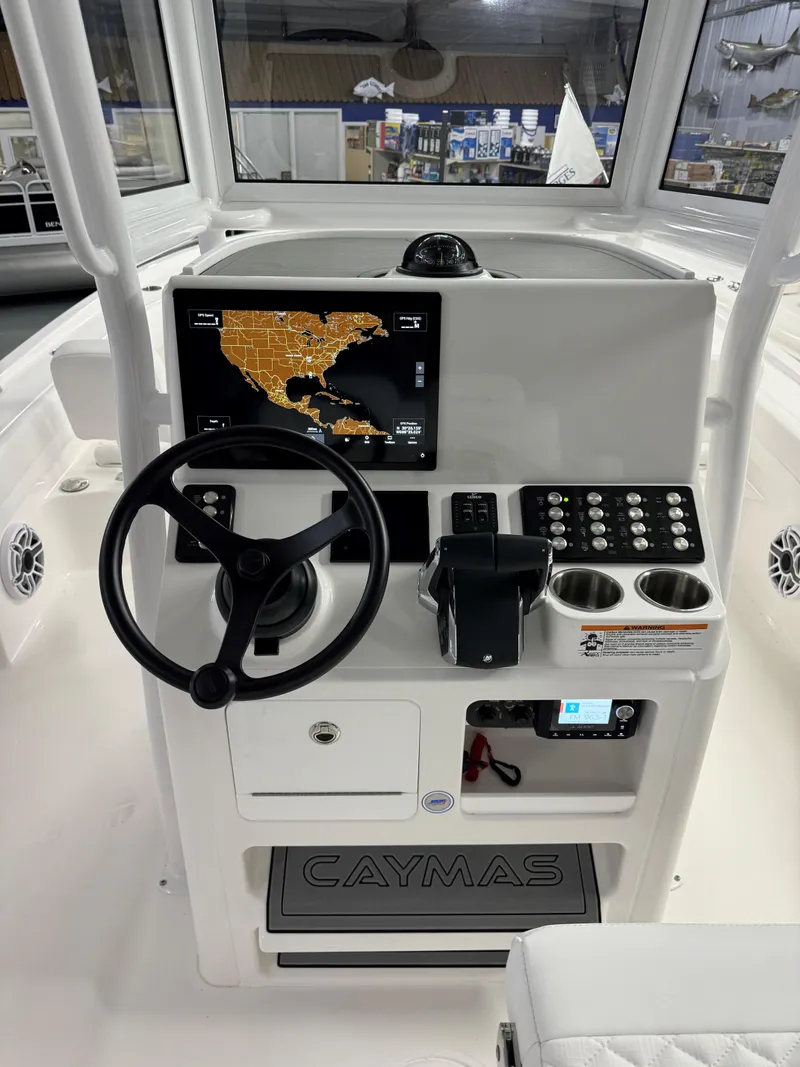 Slide: The Image of 2025 Caymas 281 HB boat dashboard with navigation screen and controls. - 35