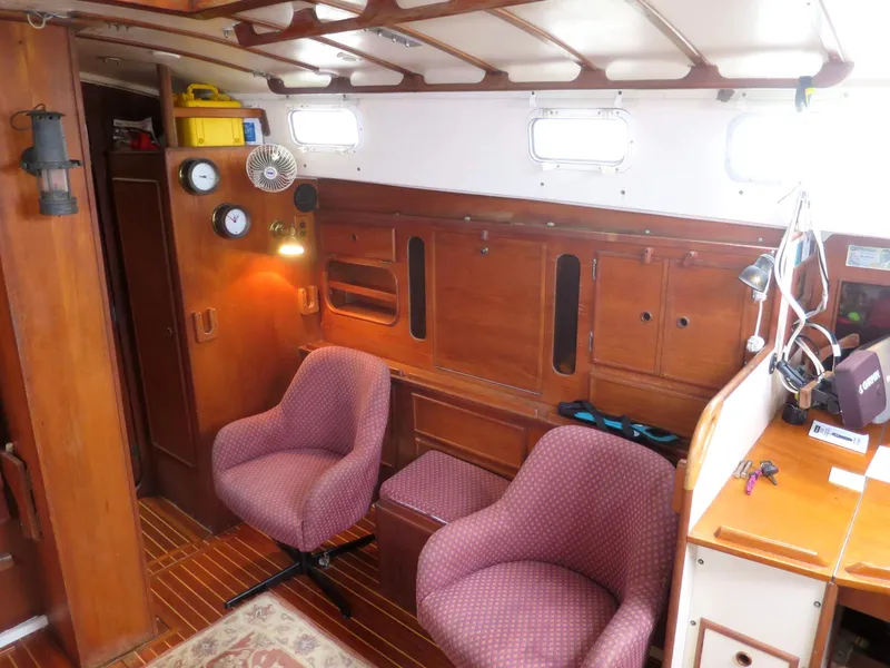 Slide: The Image of Interior of 1984 Whitby 42 Ketch with wooden paneling and two upholstered chairs. - 20