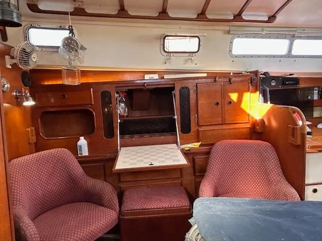 Slide: The Image of Interior of 1984 Whitby 42 Ketch with cozy seating and wooden cabinetry. - 22
