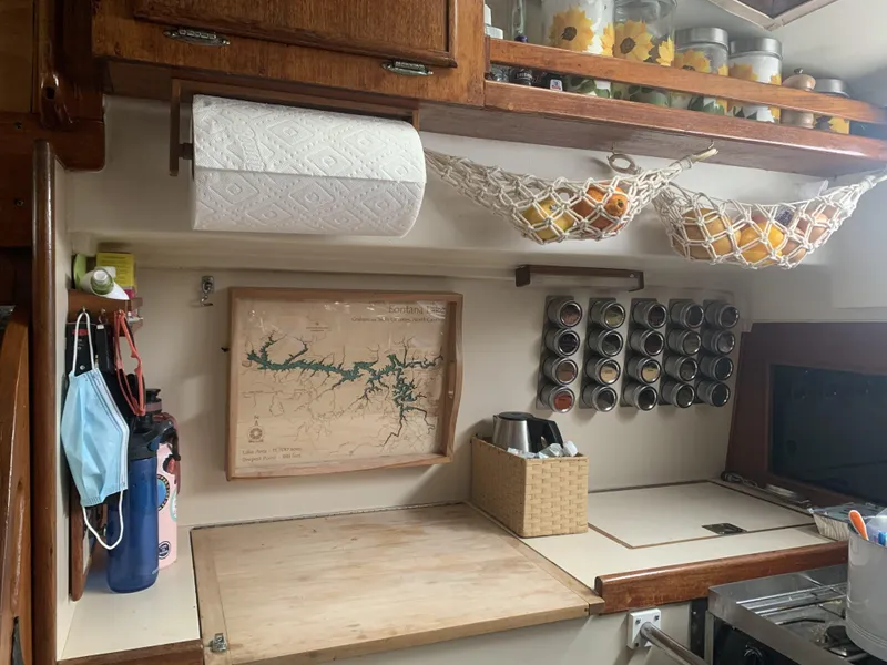 Slide: The Image of Cozy kitchen in 1984 Whitby 42 Ketch with spices, map, and fruit hammock. - 28